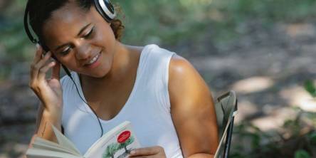 Woman Reading Book In Headphone