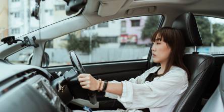 Asian woman driving a car