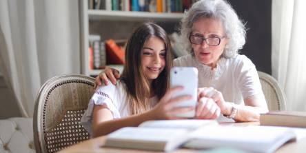 Older woman and a young girl taking a selfie.