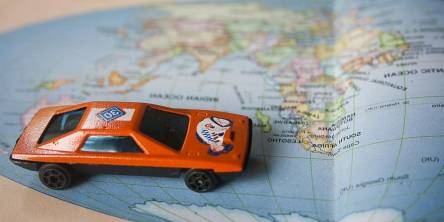 Toy car on map of the world