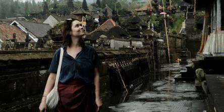 A woman looking up at Bali temple