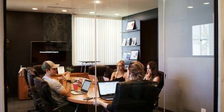 A recruitment agency team guiding employees in a meeting to avoid burnout.