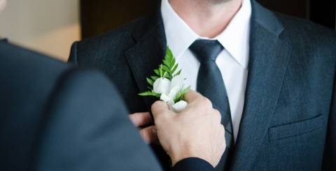 Groom being given flower