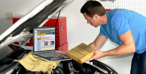 car repair pro looking into the car's hood