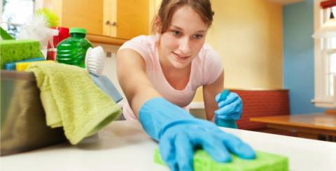 housekeeper wiping down the counters
