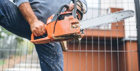 a timber worker using a chainsaw