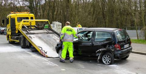 A towing truck removing accidental vehicle car removal process