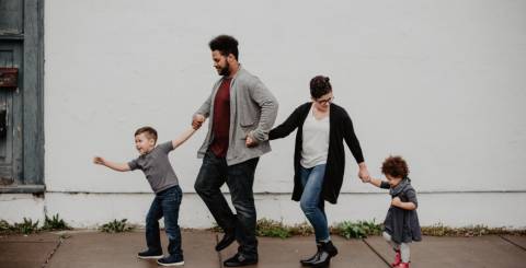 A family walking together consisting of a mother, father, son and daughter