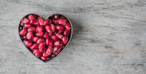 A heart made out of pomegranate seeds. 