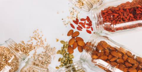 5 seeds and nuts that count as superfoods spilled on a while table