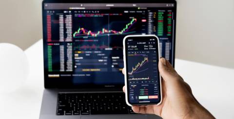 Stock Exchange graph on laptop and mobile screen Stock Exchange graph on laptop and mobile screen