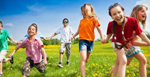 happy children running in the grass