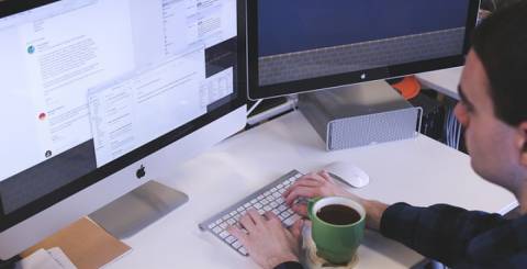 man typing on computer