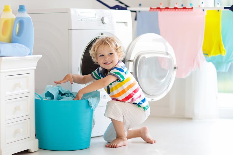 child doing laundry