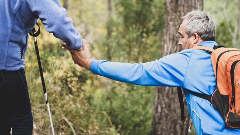 Active senior couple hiking in a forest